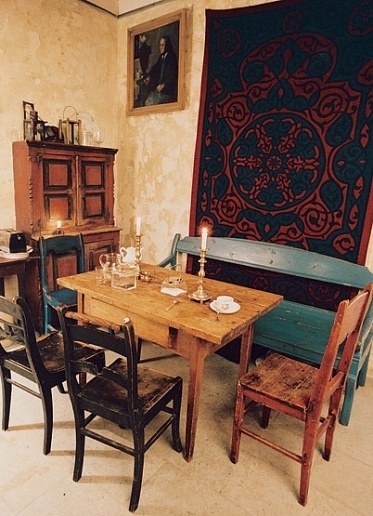 The table in the kitchen seems Scandinavian, but it's from northern Russia, he notes. The styles have a lot in common.